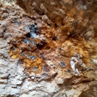 a close up of a rock with a blue and brown color